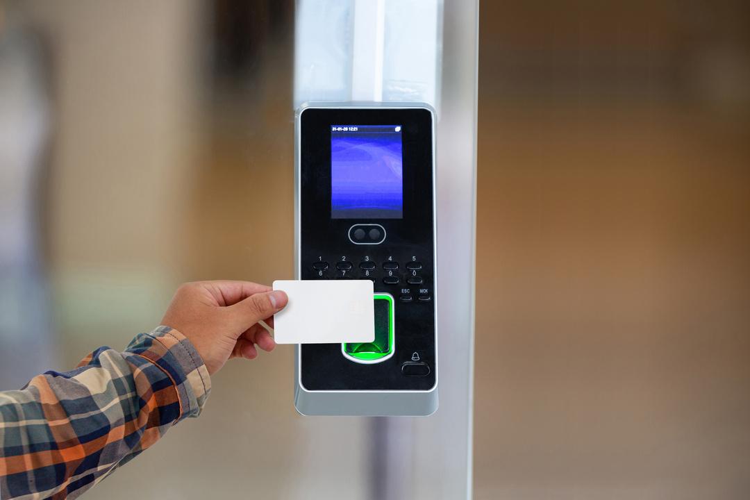Holding key card to access the door security systems.